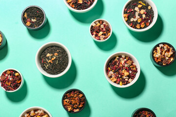 Assortment with different types of dried fruit tea on turquoise background