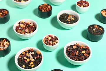 Assortment with different types of dried fruit tea on turquoise background