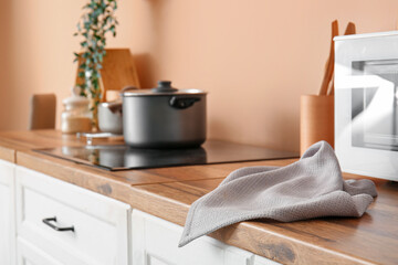 Napkin on wooden kitchen counter near microwave oven