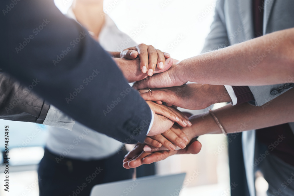 Poster their hard work really adds up. a group of unrecognizable businesspeople piling their hands on top o