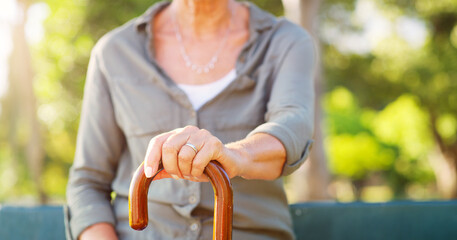 Her youth has faded and shes embraced her cane. an unrecognizable senior woman holding onto her walking stick outdoors.