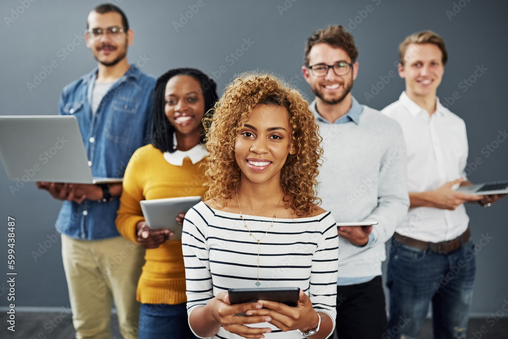 Poster Were always connected. Studio portrait of a group of businesspeople using wireless technology together while standing in line against a gray background.