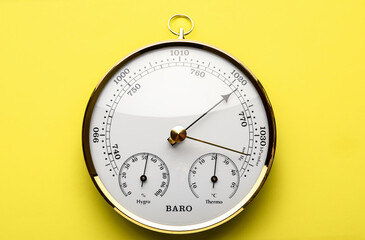 Aneroid barometer on yellow background