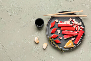 Plate with tasty crab sticks and sauce on light background © Pixel-Shot