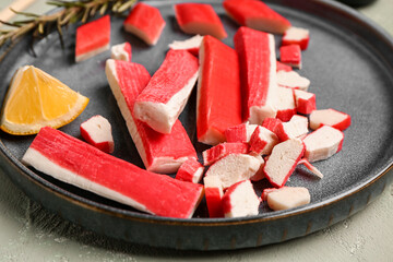 Plate with tasty crab sticks on light background, closeup © Pixel-Shot