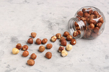 Jar with hazelnuts on grey grunge background