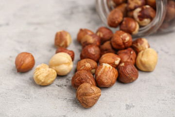 Jar with hazelnuts on grey grunge background