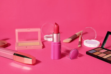 Obraz na płótnie Canvas Lipstick and different cosmetics on pink background