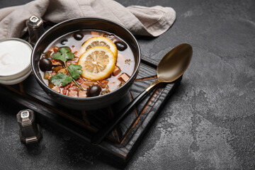 Bowl of tasty Hodgepodge soup on dark background