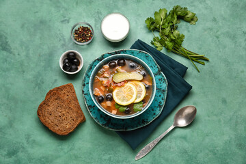 Bowl of tasty Hodgepodge soup with bread and sour cream on grunge background