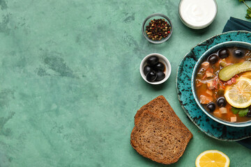 Bowl of tasty Hodgepodge soup with bread on grunge background, closeup