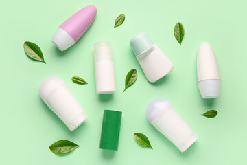Deodorants with leaves on light green background