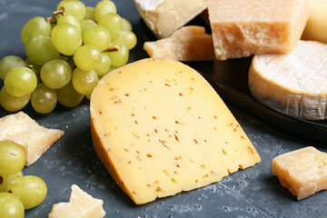 Piece of tasty cheese on blue background