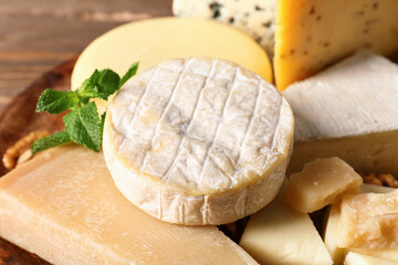 Different types of tasty cheese on table, closeup
