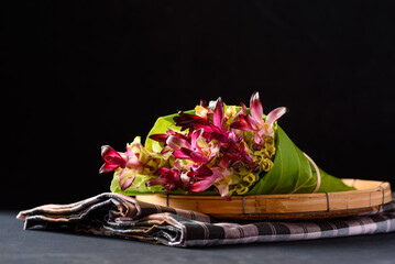 Natural fresh pink edible flower are an ingredient in local cuisine on black background