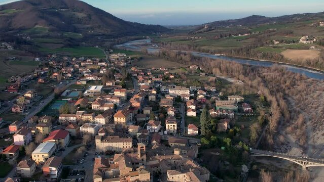 Aerial reveal drone footage at sunset of Travo Village in Trebbia River Valley, Piacenza, Italy
