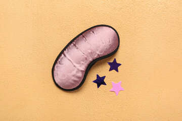 Sleeping mask and stars on orange background