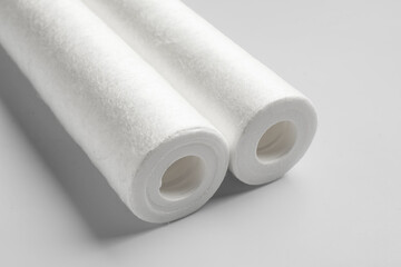 New water filter cartridges on grey background, closeup