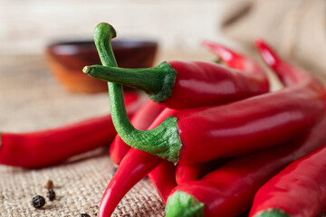 Heap of fresh chili peppers on table, closeup