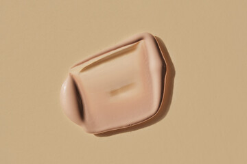 Foundation swatch with spf on a beige.