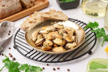 Plate of pickled mussels on grey background