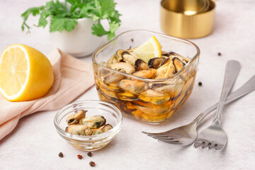 Bowls with pickled mussels on white background