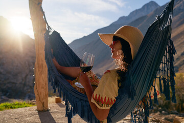 young woman in a hammock relaxed holding a glass of wine in Elqui Valley Paihuano province
