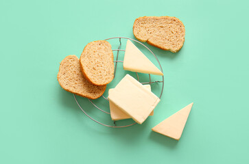 Stand with processed cheese and bread on turquoise background