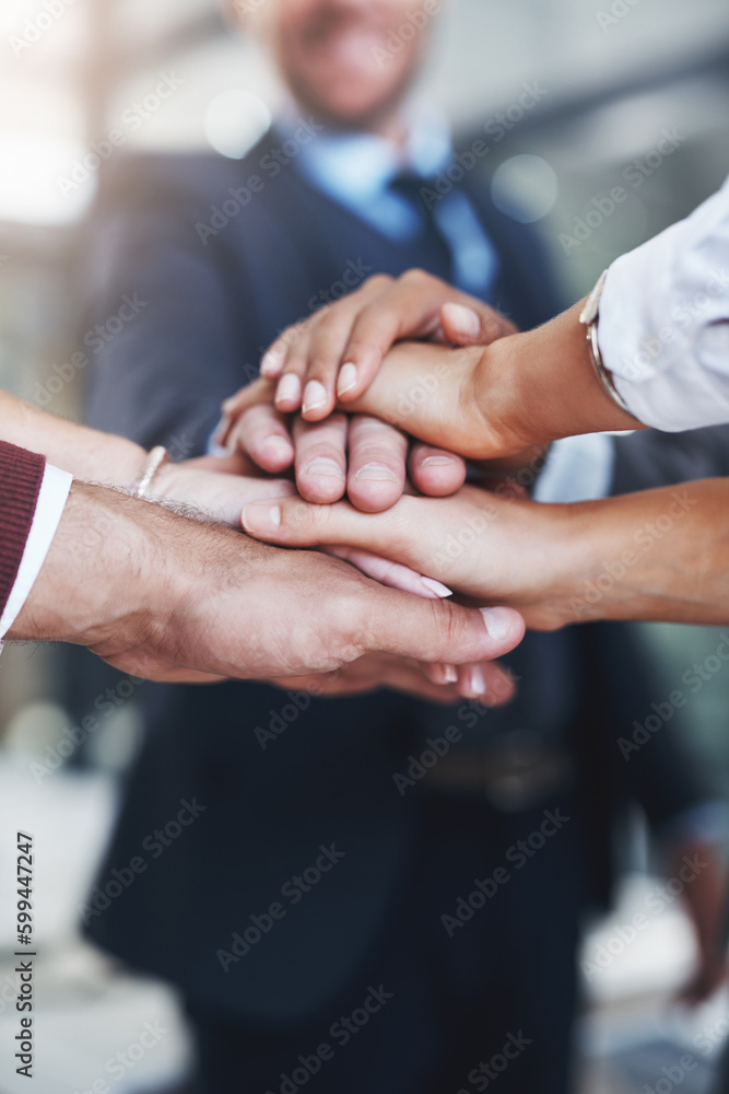 Poster we do it better together. a group of unrecognizable businesspeople piling their hands on top of each