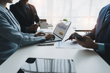 Group of business people brainstorming in analytical plan meeting Calculate the numbers obtained...
