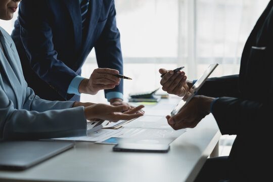 Startup business concept. Business people, group of business people meeting about investment and financial growth. From statistics, graphs, charts, teamwork, focus on data on tablet.