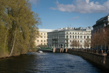 Moika River embankment along New Holland and the building of the Museum and Exhibition Center St. Petersburg Artist on a sunny spring morning, Saint Petersburg, Russia