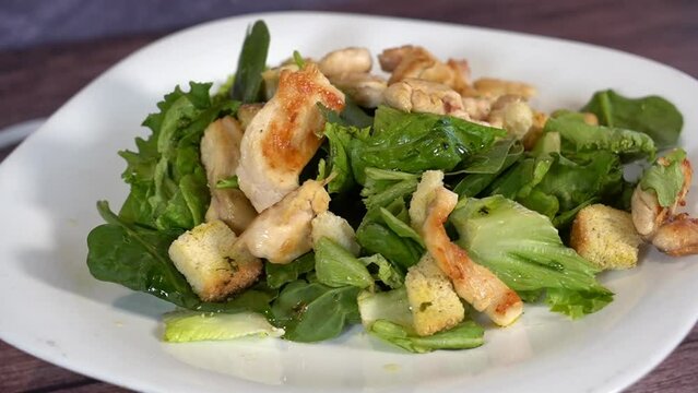 rich chicken salad with spinach and olive oil for lunch or snack.
Fresh salad with chicken breast, spimach. Top view
