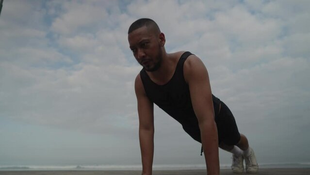 LGBT Queer Gay Man Male Warming Up Exercise on the Beach - Body Movement, Stretching, Jogging, Push Ups and Skipping
