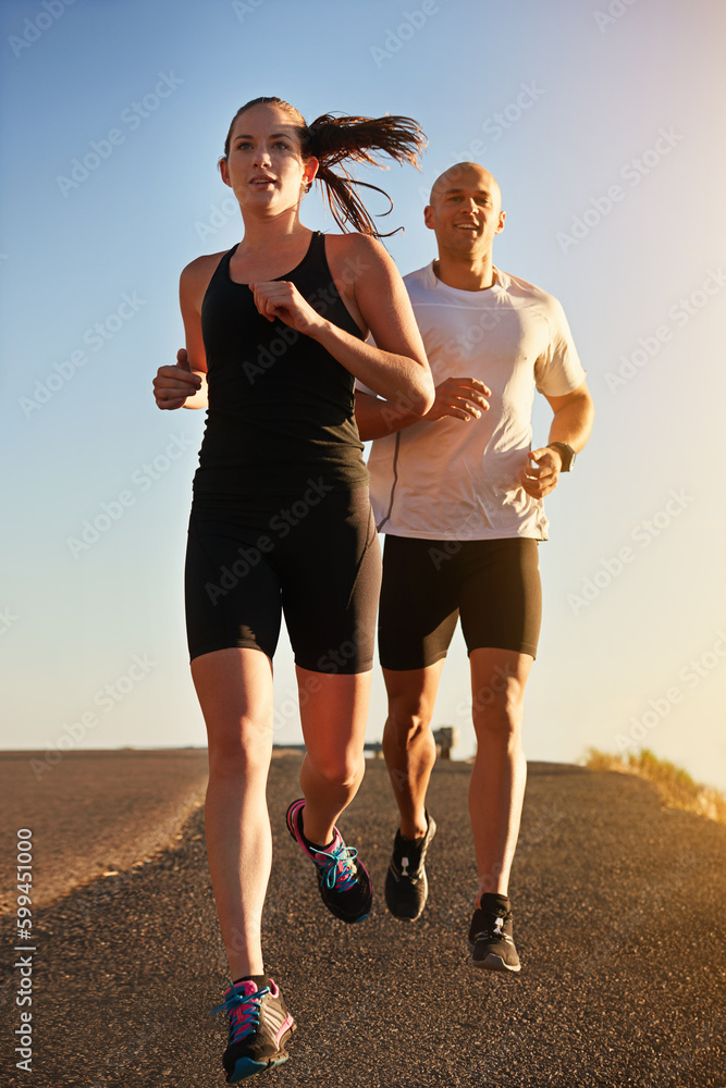 Canvas Prints Hitting the road together. a young couple running together along a road.