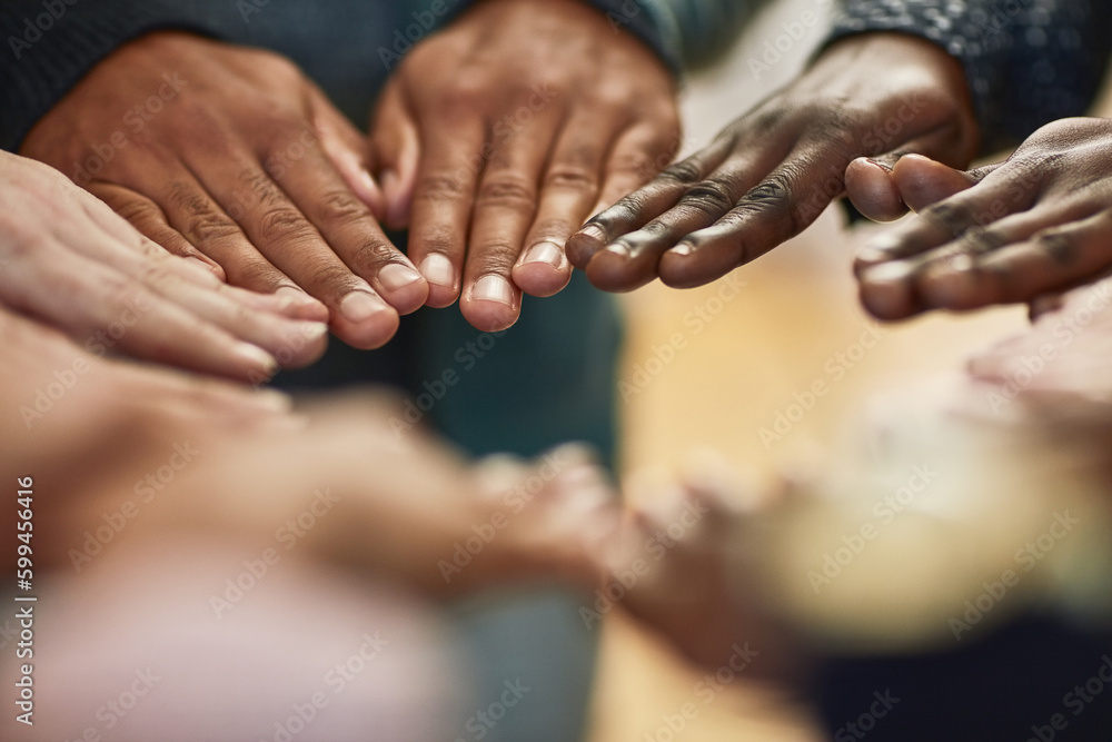 Poster Uniting together no matter their differences. Closeup shot of a group of university students joining their hands together in unity.