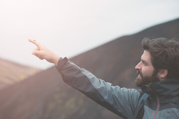 A young guy is holding a ladybug in the hand.