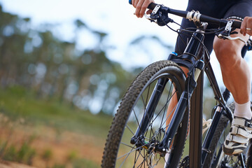 Mountain biking is addictive. Cropped view of a cyclist exploring outdoor terrain on his bike.