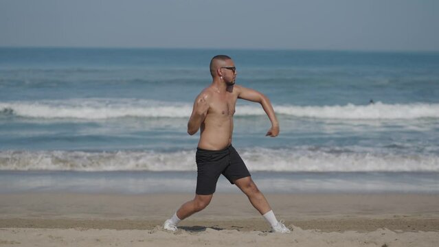 Handsome LGBT Queer Gay Man Male Dancer Dance on the Beach with Confidence Topless on a Blue Sunny Day