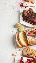 Table with various cookies, cakes and fruits. Delicious dessert table.