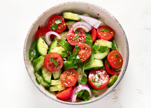 Fresh salad on light background. Top view.