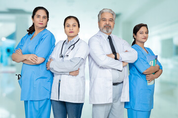 Group of confident indian male and female doctors and nursing staff with stethoscope standing cross...
