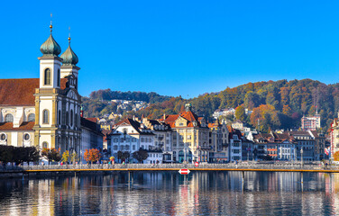 Obraz premium Chapel wooden bridge(240meters long) over the river Reuss of the city of Lucerne in central Switzerland is the oldest wooden bridge in Europe. And the Jesuit Church in Lucerne Central.