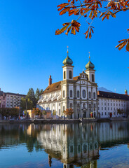 Fototapeta premium Chapel wooden bridge(240meters long) over the river Reuss of the city of Lucerne in central Switzerland is the oldest wooden bridge in Europe. And the Jesuit Church in Lucerne Central.