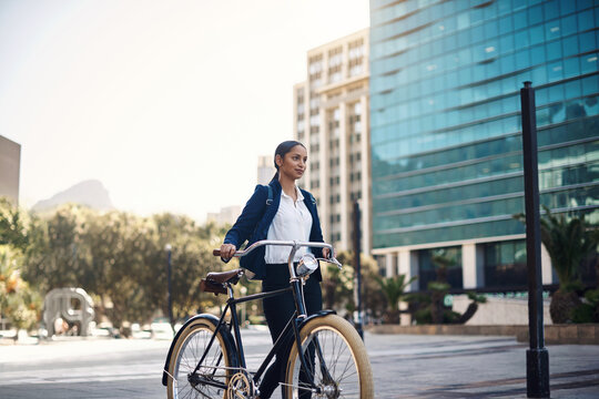 Transport, walking and businesswoman with a bicycle in the city, morning and street for work routine. Eco friendly, travel and professional female employee commuting to office with bike in urban town