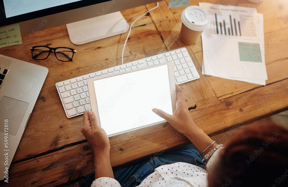 Wall mural Technology plays host to a world of information. High angle shot of an unrecognisable businesswoman using a digital tablet in an office at night.