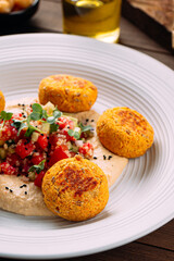 Portion of vegetarian falafels with hummus and vegetables