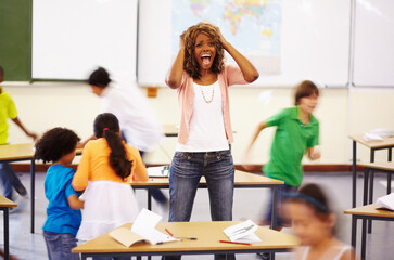 Stress, teacher screaming and black woman in classroom with children running around. Education,...