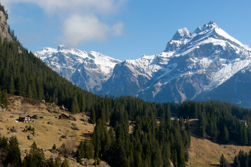 Picturesque mountain view in the Swiss Alps, spring. Blue sky, high mountains covered with snow...