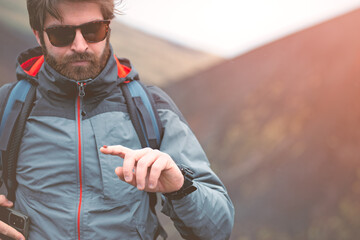 A young guy is holding a ladybug in the hand.